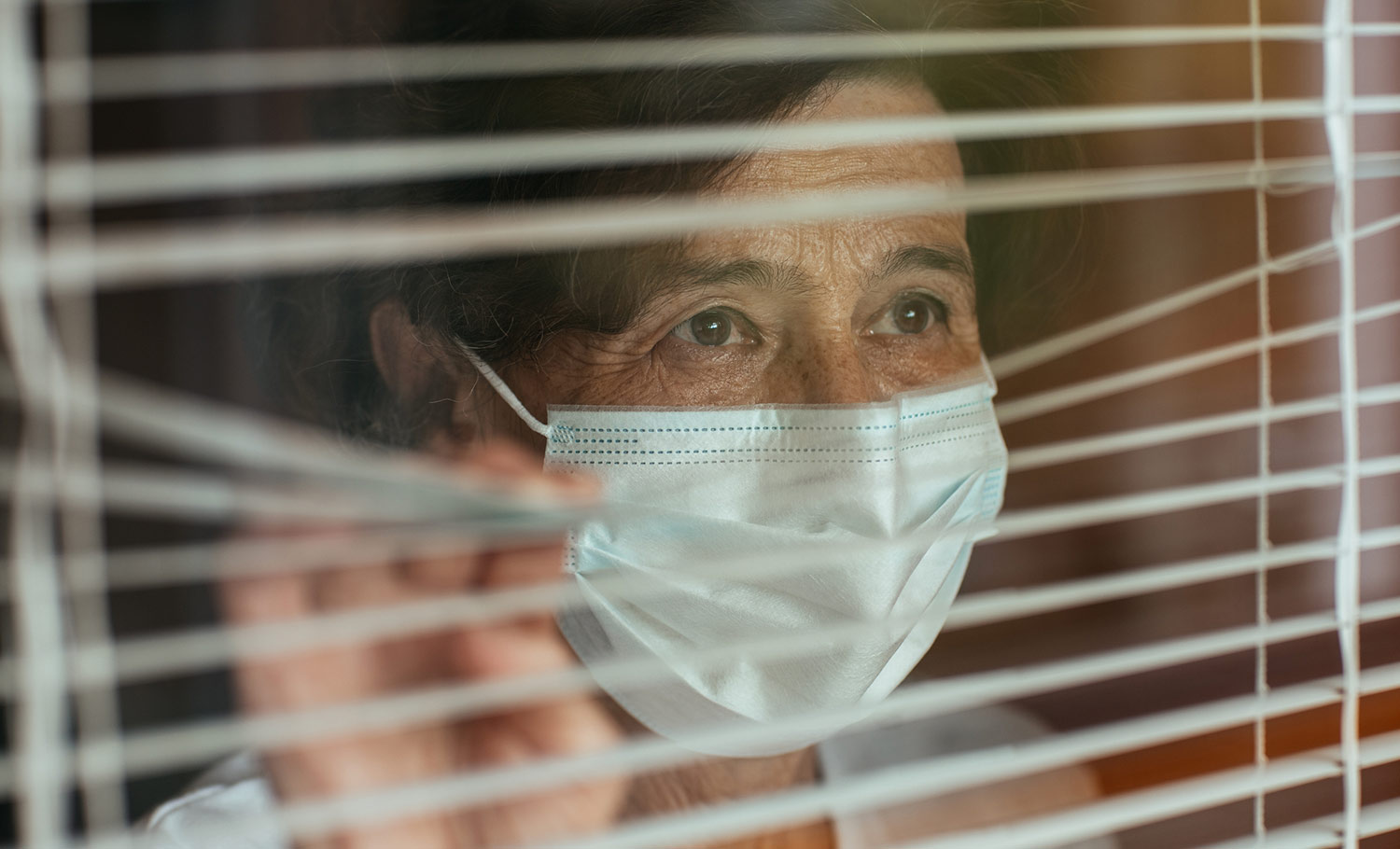 senior patient in nursing home looking out the window