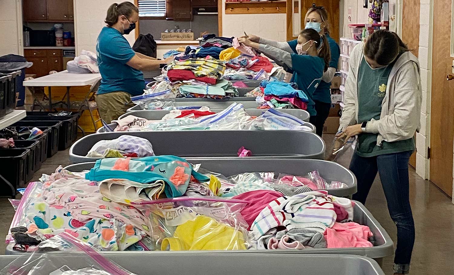 volunteers working with clothing bins