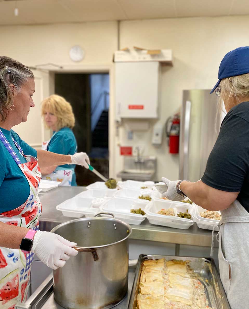 volunteers cooking meals