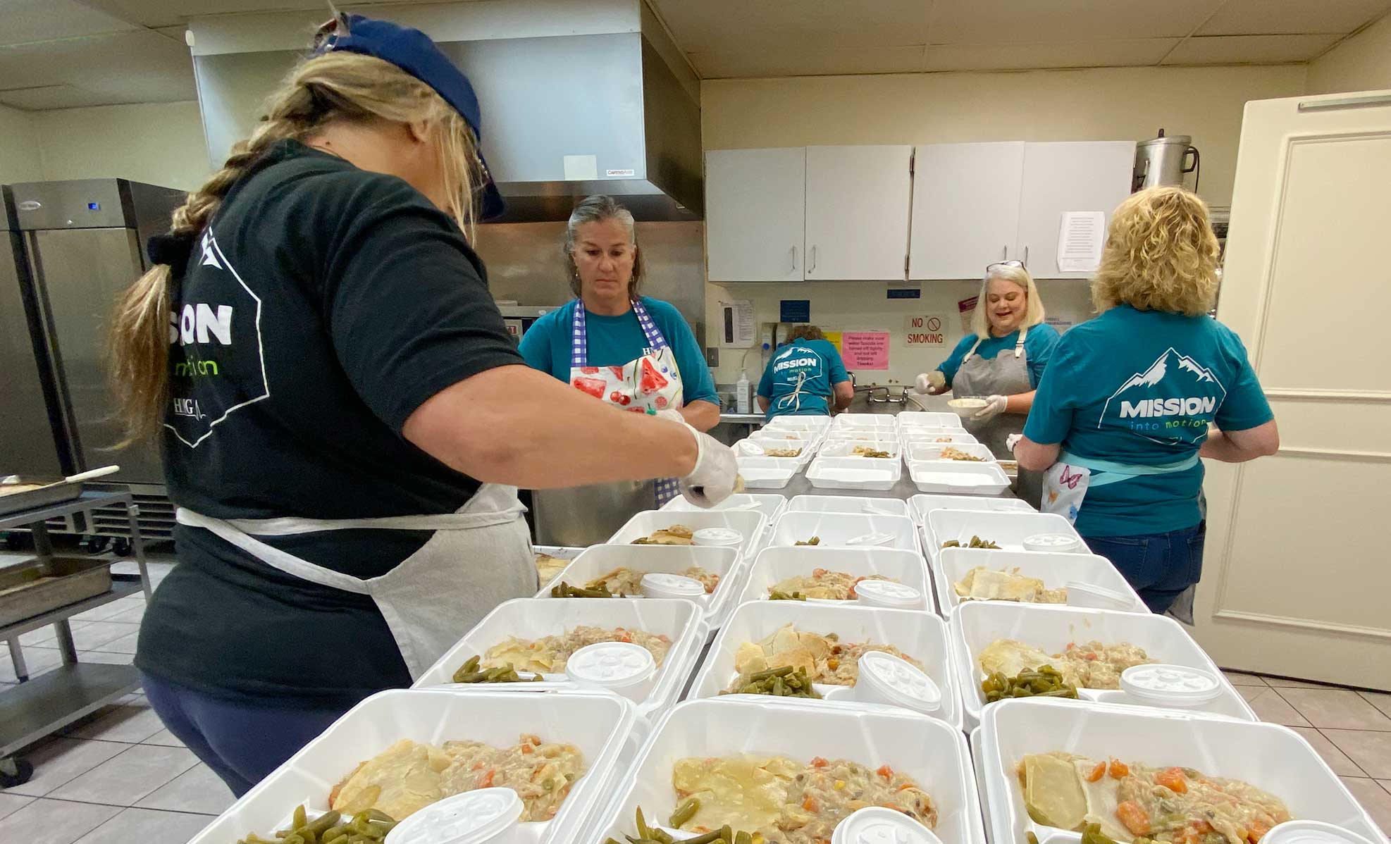 volunteers boxing up meals