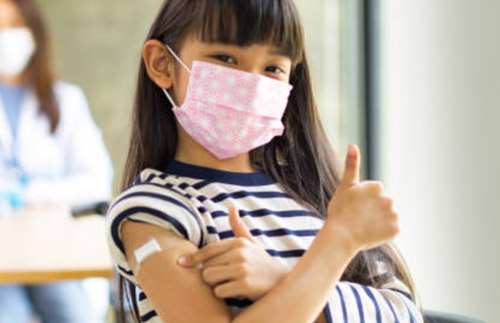 child with bandaid after vaccination