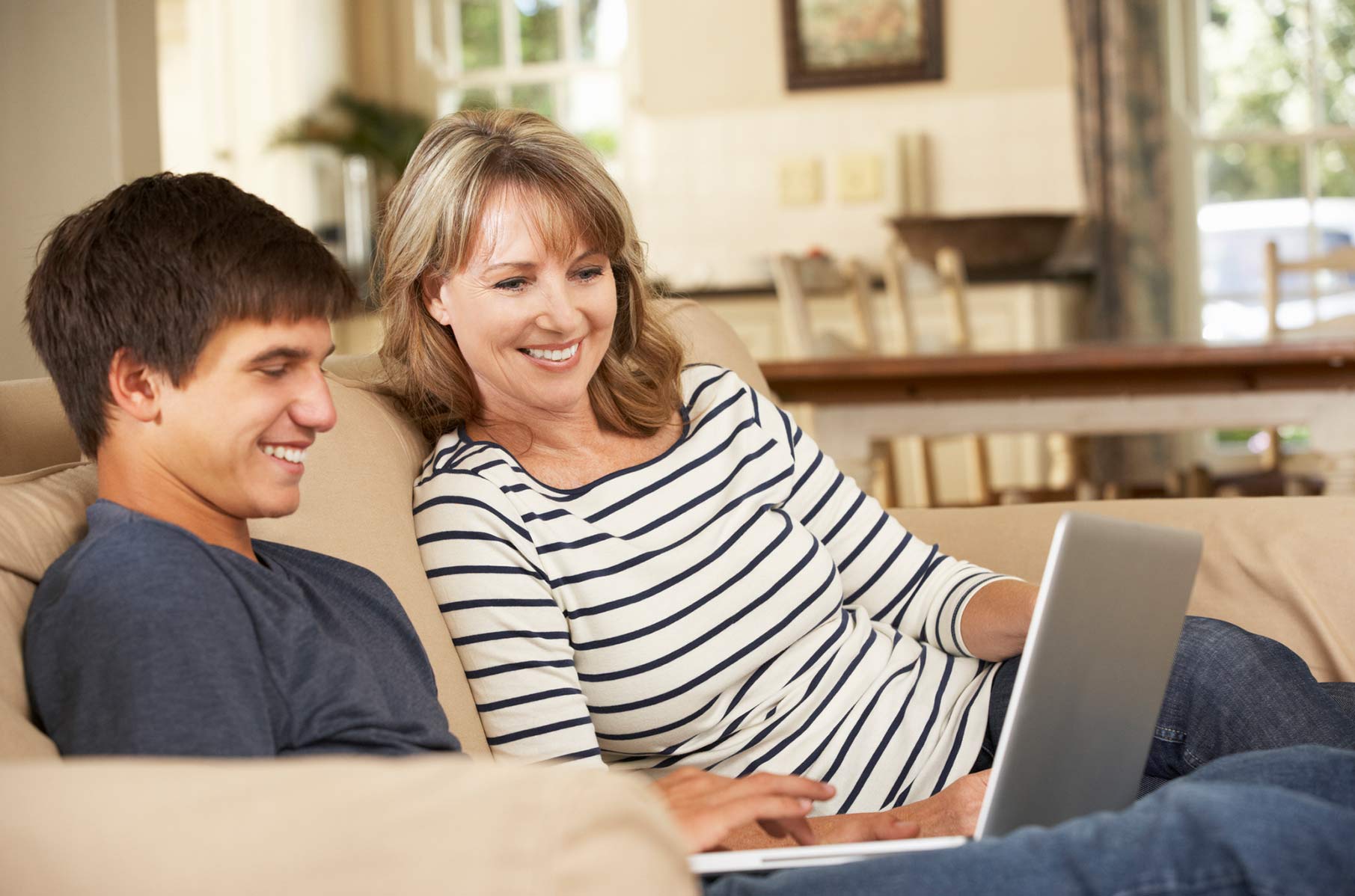 Mom using online health portal with teenage son