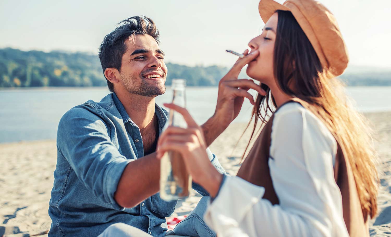 couple smoking on the beach