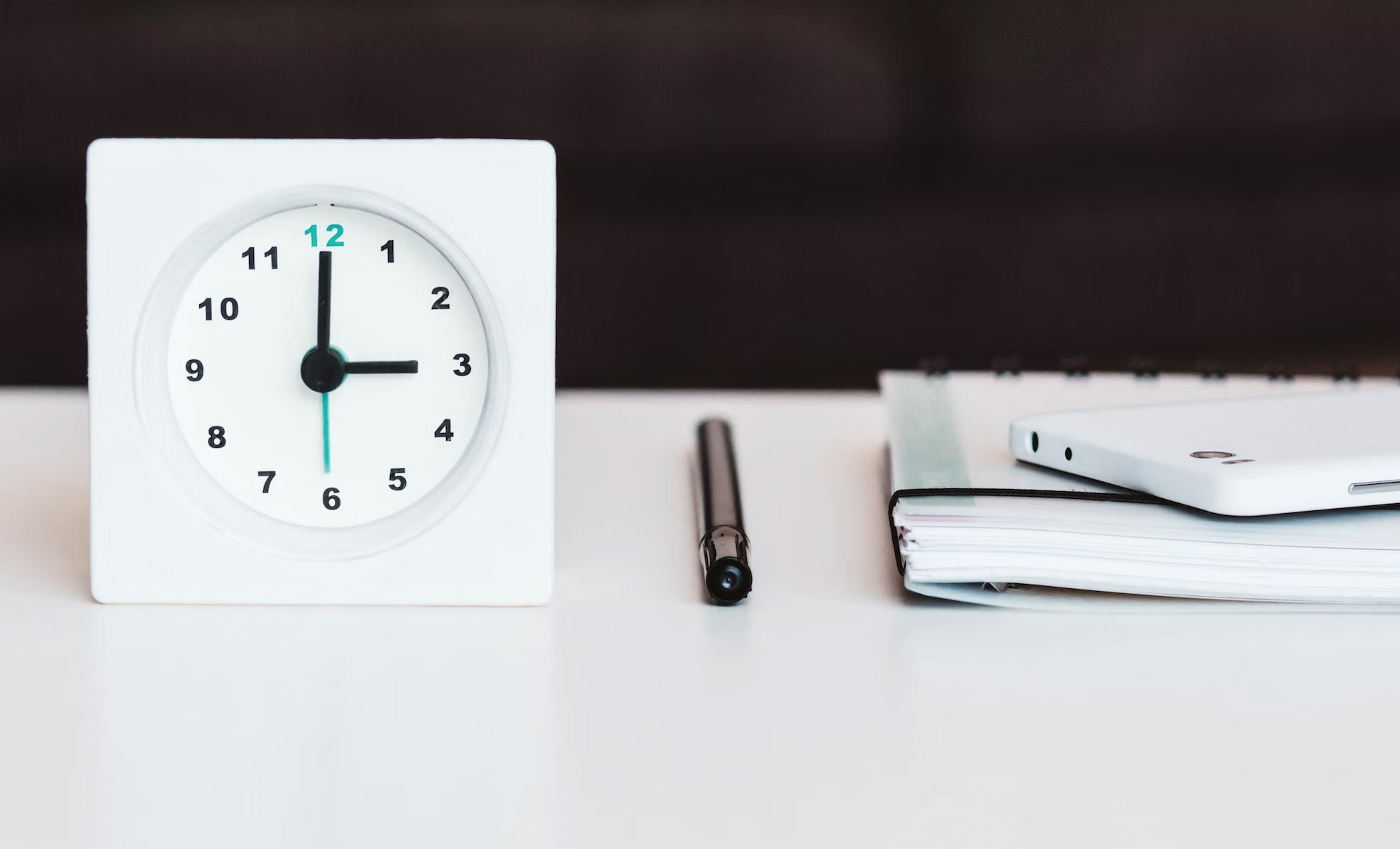 clock and pen with planner book