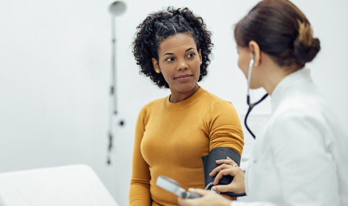 nurse getting blood pressure from a patient