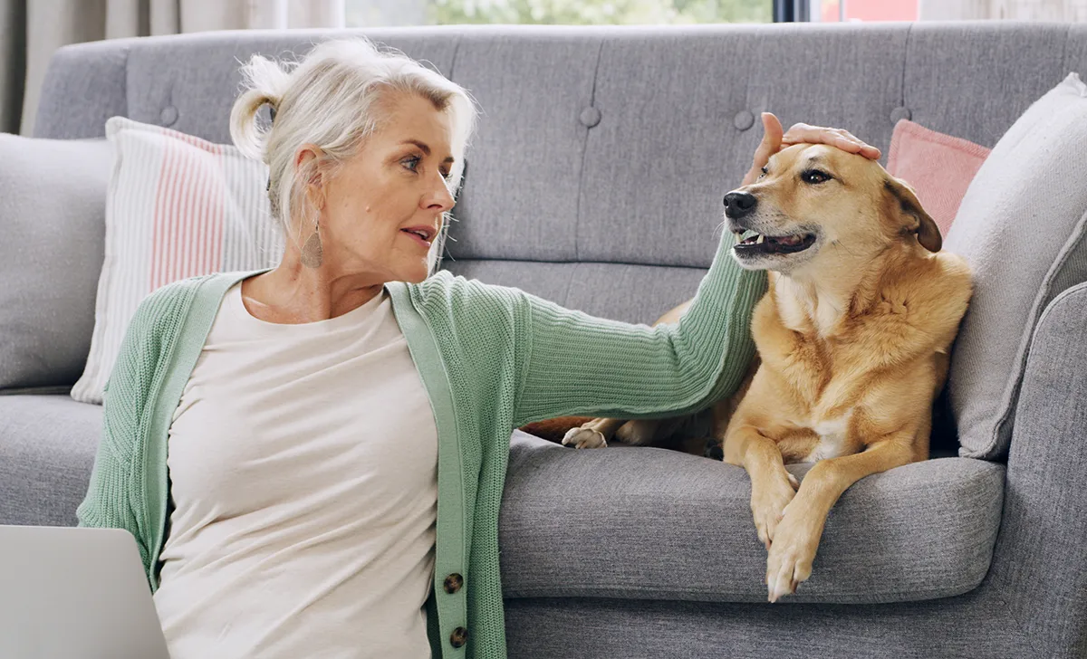 senior woman on the couch with her dog