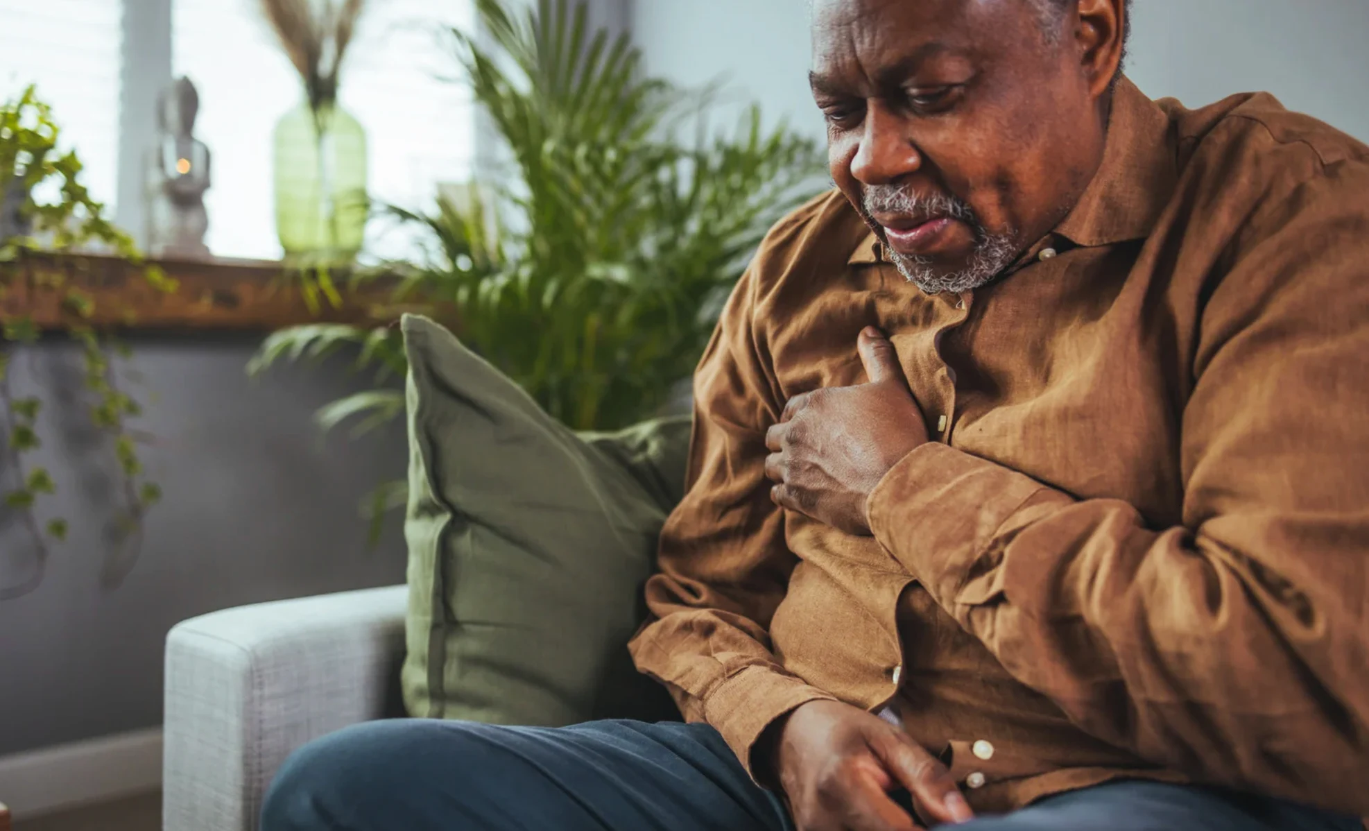Person reading a book by the window on a cold day