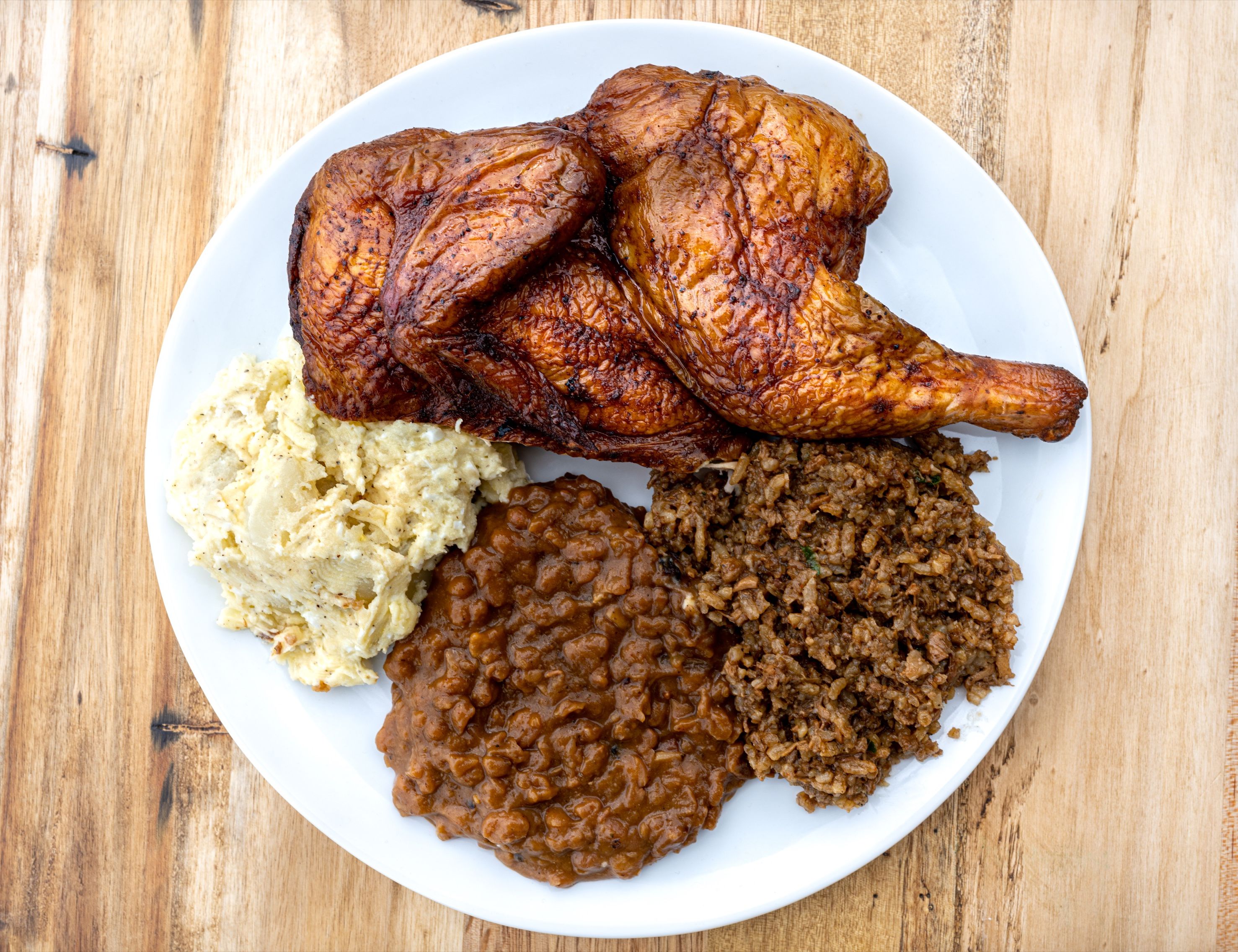 Barbecque plate lunch with beans chicken and rice dressing