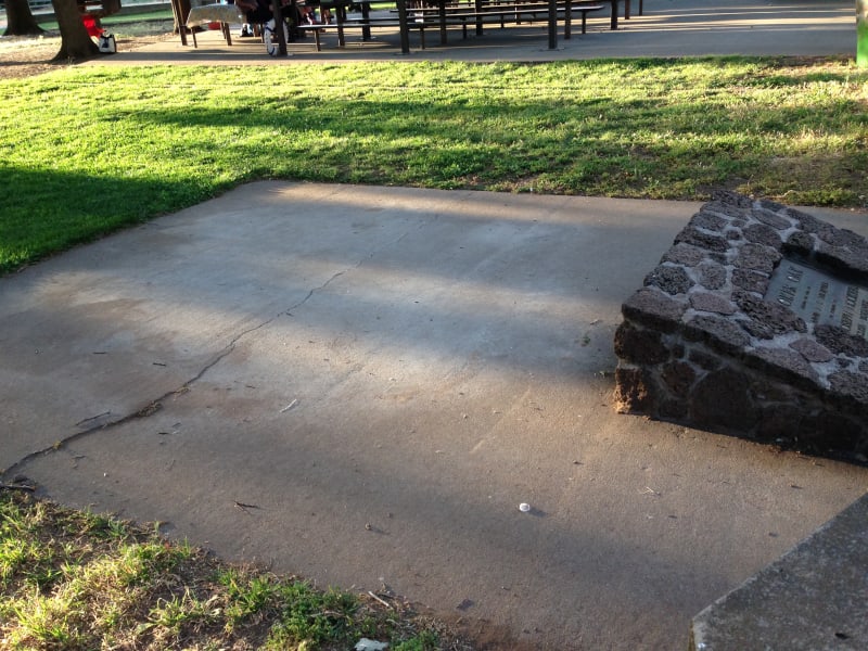 After vandals burned the stump, everything was removed and paved with cement.