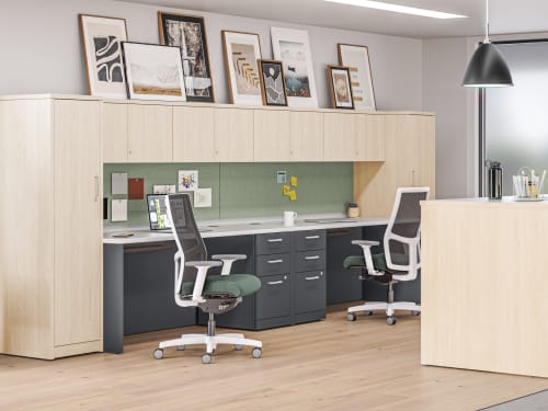 10500 Series desks with personal towers and overhead storage near Storage Island collaborative workspace.