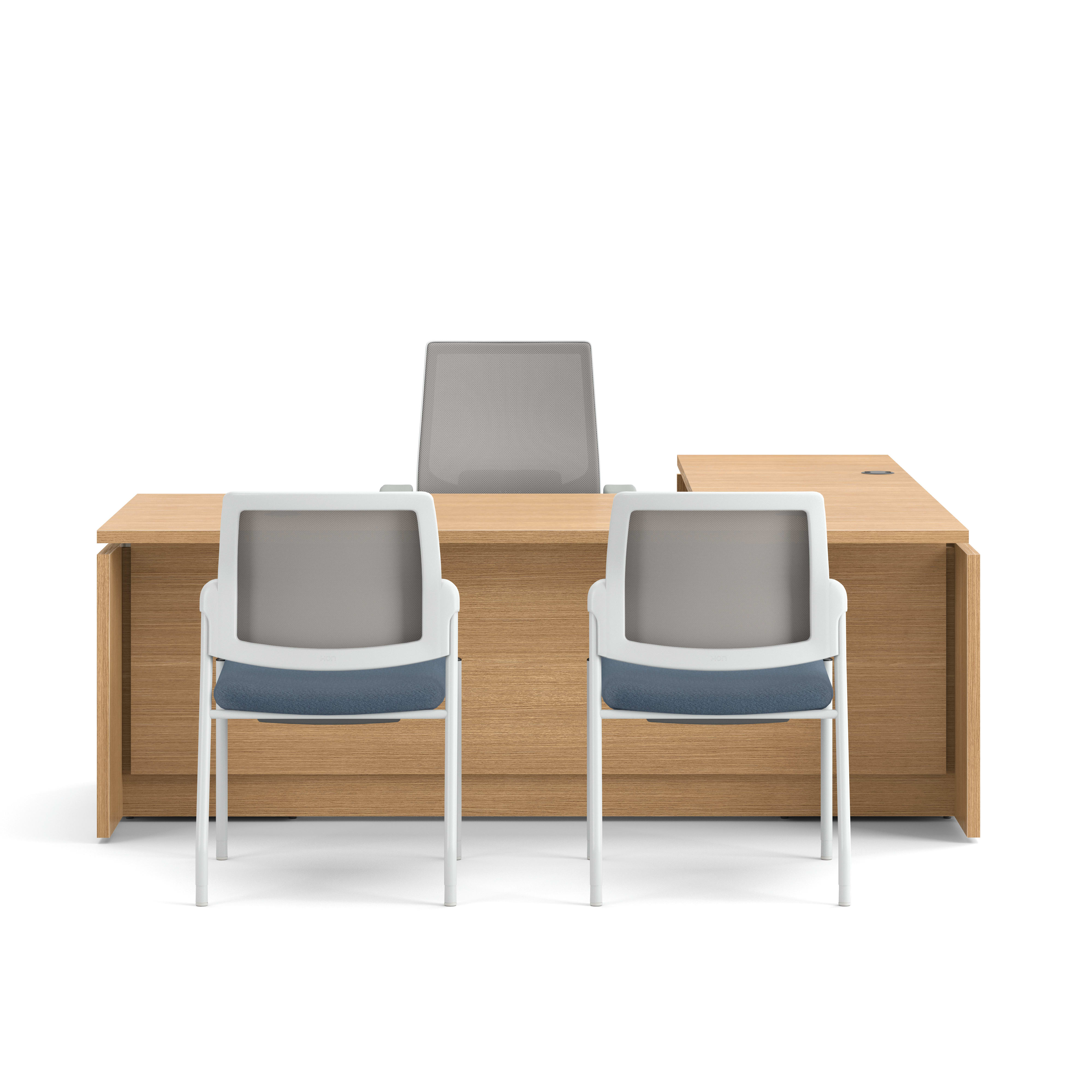 Modern wood office desk with return, mesh task chair, and two guest chairs with blue upholstered seats.