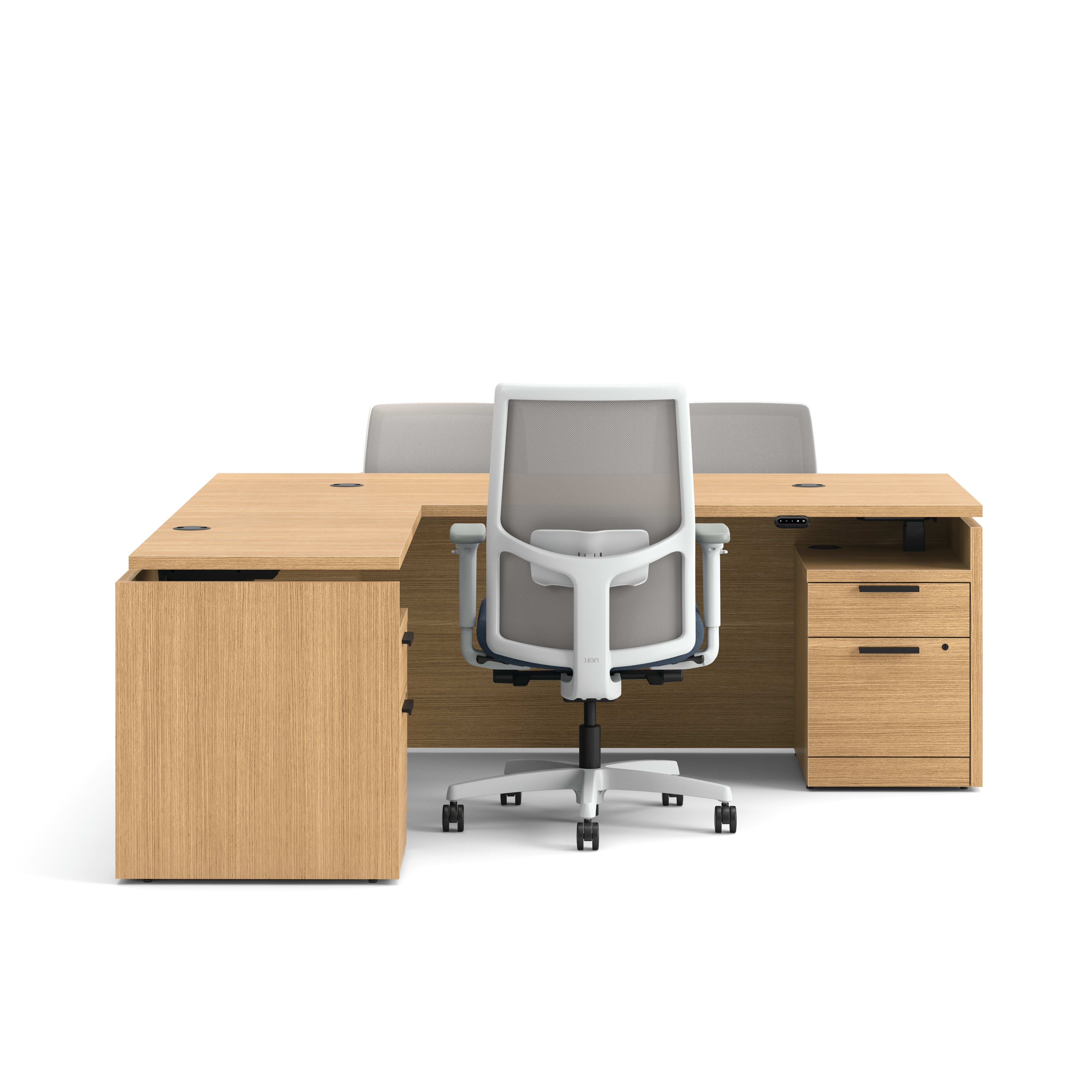 Modern wood office desk with return, mesh task chair, and two guest chairs with blue upholstered seats.
