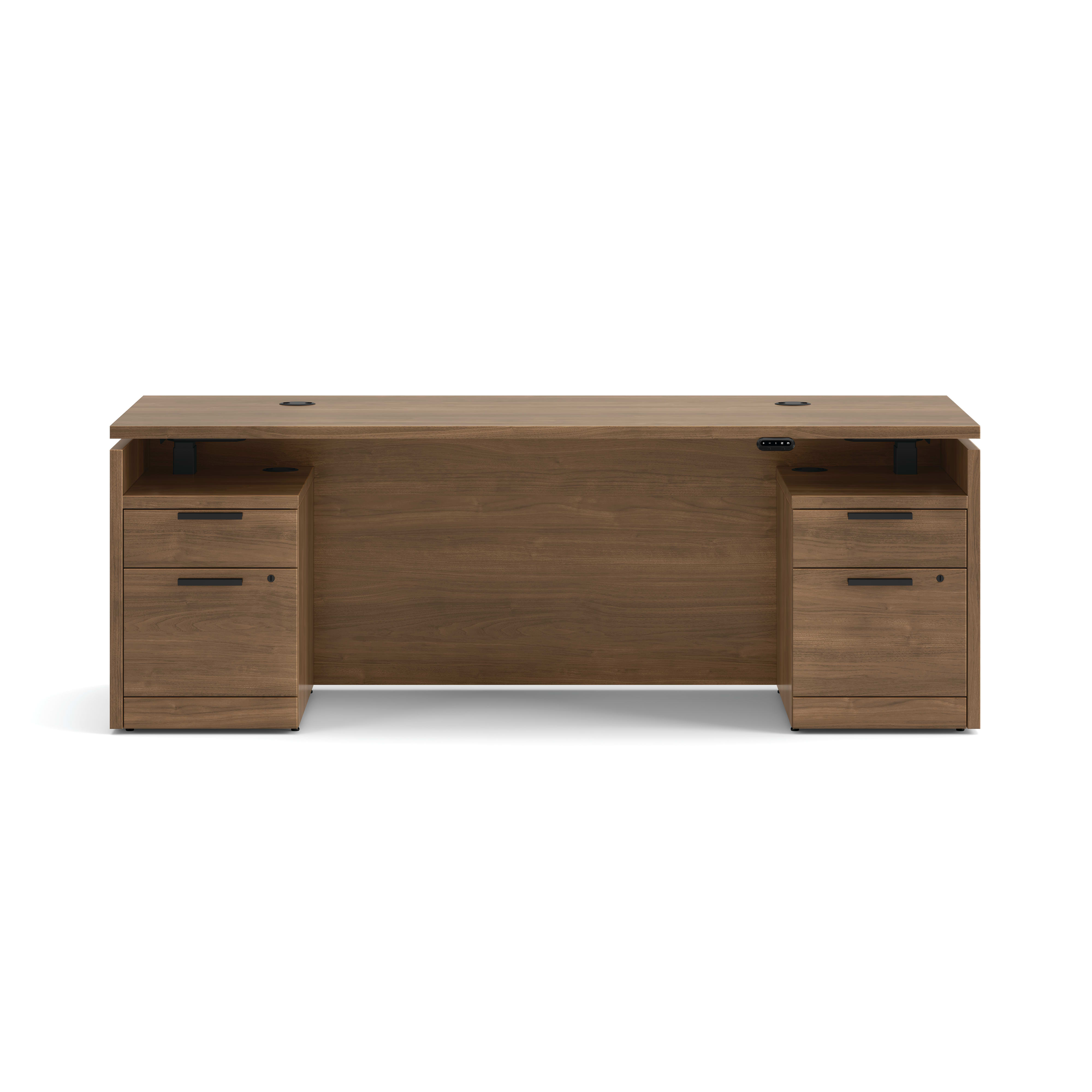 Double pedestal executive desk with woodgrain finish, integrated power access, and built-in file storage.