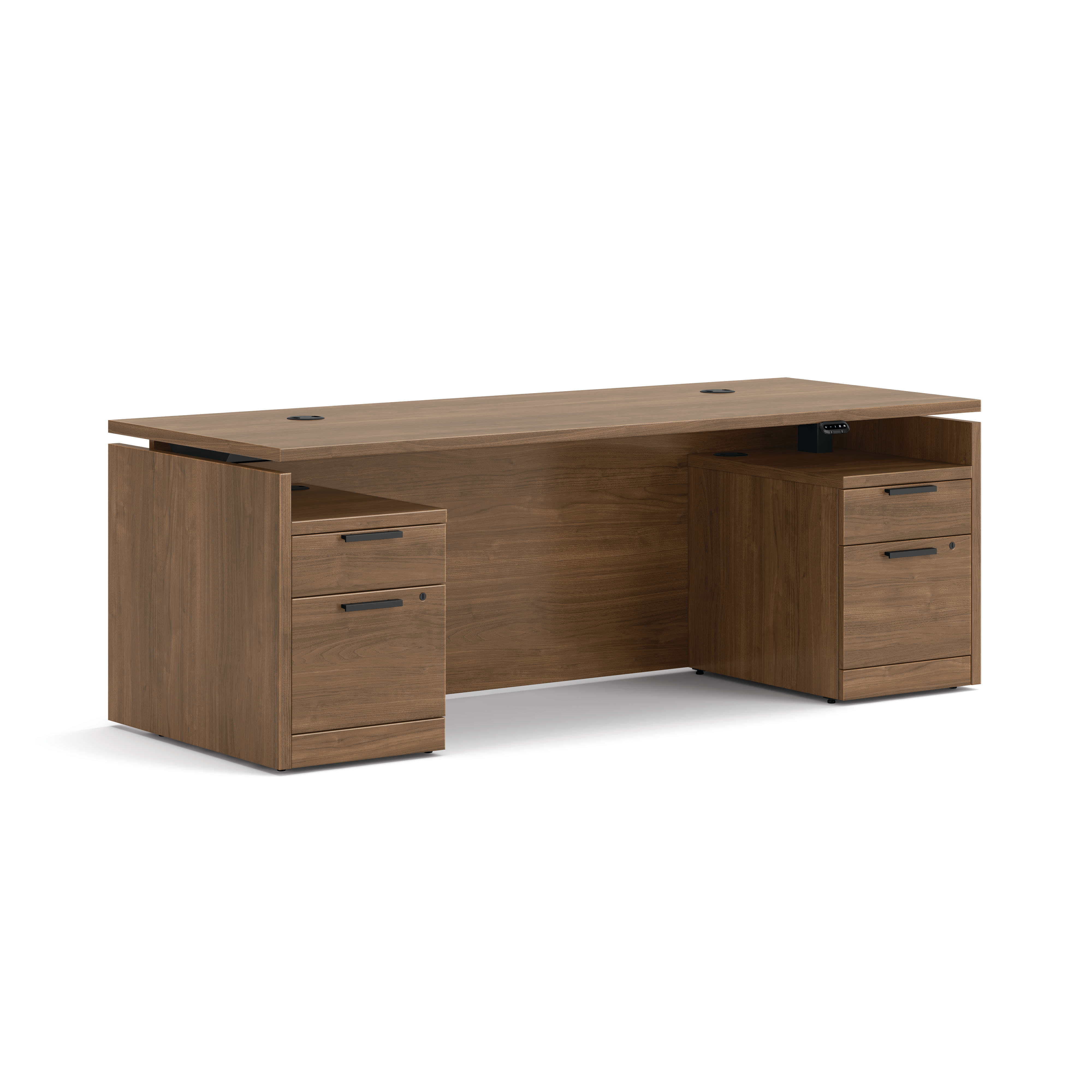 Double pedestal executive desk with woodgrain finish, integrated power access, and built-in file storage.