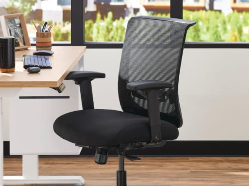 Two white Coordinate Height-Adjustable Bases paired with Coze desk tops and Convergence Task chairs in a small office setting