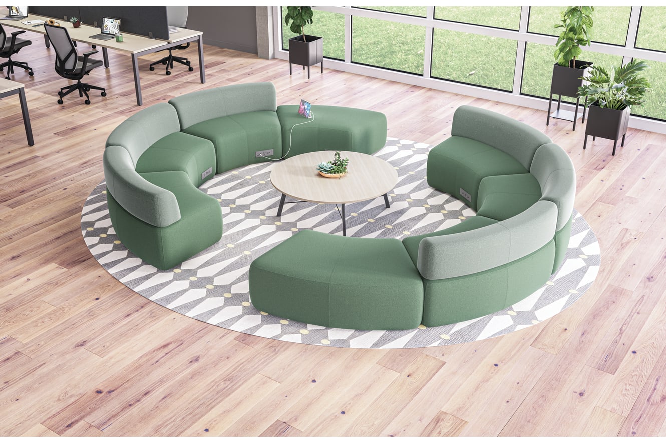 SoCo multi-fabric modular lounge in collaborative area with Scramble table and Sculpt planters near Empower workstations.