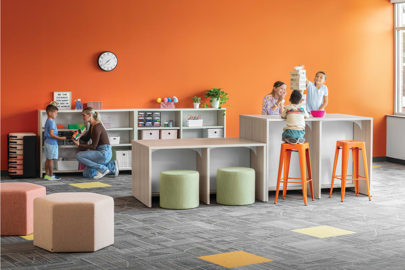 Storyline Linear Bookcases and Bistro Tables with Tangram Poufs and Flock Minis.
