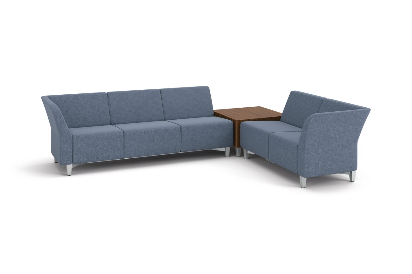 Flock 3-seat and 2-seat sofas in L-shape layout with cube table in between.