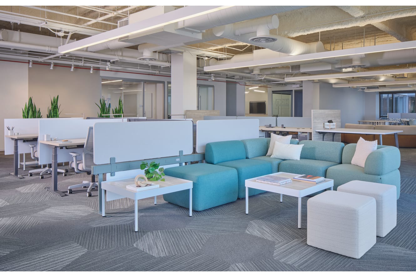 SocCo shown with Sculpt tables and Flock lounge seats, next to Gravitation power beam & screens with Coordinate height adjustable desks, fuse storage, and ignition 2.0 seating. 