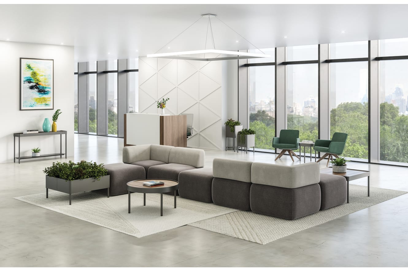 SoCo multi-fabric modular lounge in reception area with Sculpt occasional tables & planters near 10500 Series station and Mav seating.