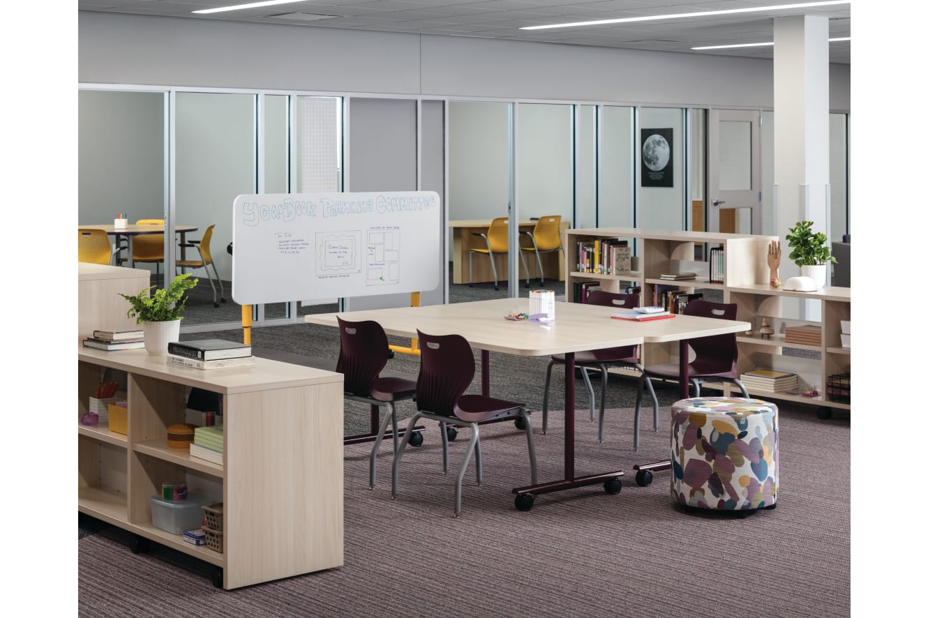 Field Trip tables with purple SmartLink chairs in a Multi-media Center with Storyline bookcases.