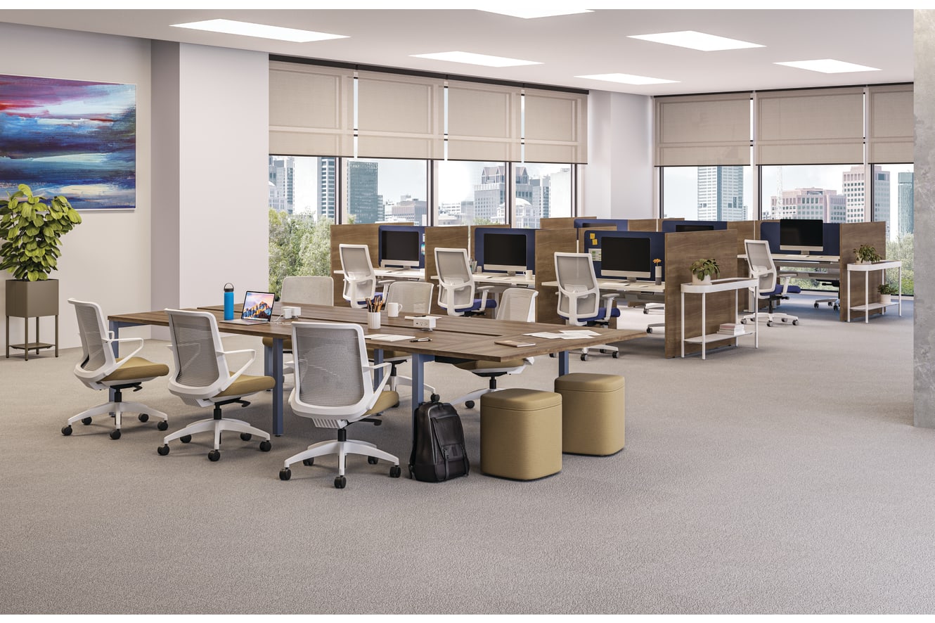 A modern and well-equipped office space with rows of desks, chairs, and computer equipment, set against a backdrop of large windows overlooking a cityscape.