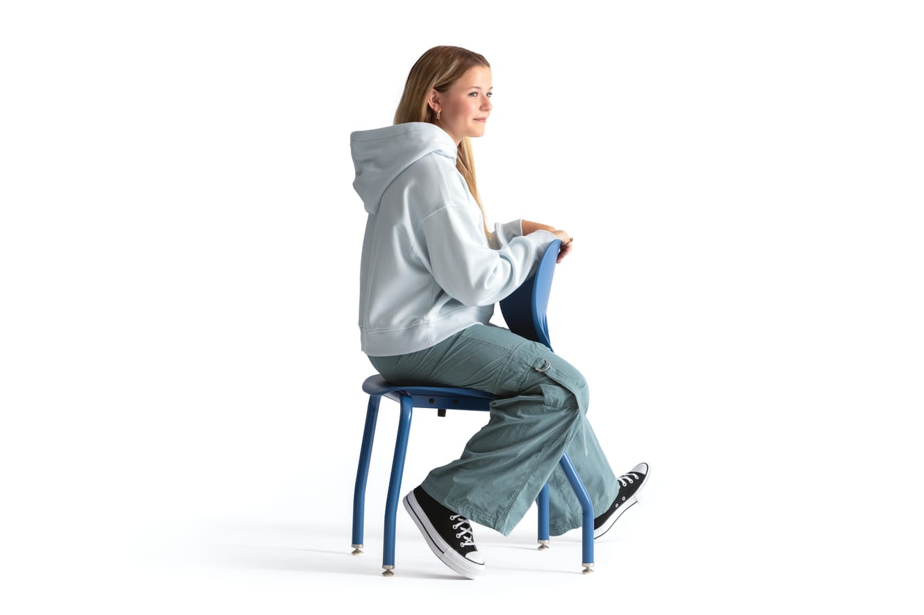 One seated student on a blue monotone Smartlink chair. One seated student on a blue monotone Smartlink chair. One seated student on a blue monotone Smartlink chair. One seated student on a blue monotone Smartlink chair. One seated student on a blue monoto
