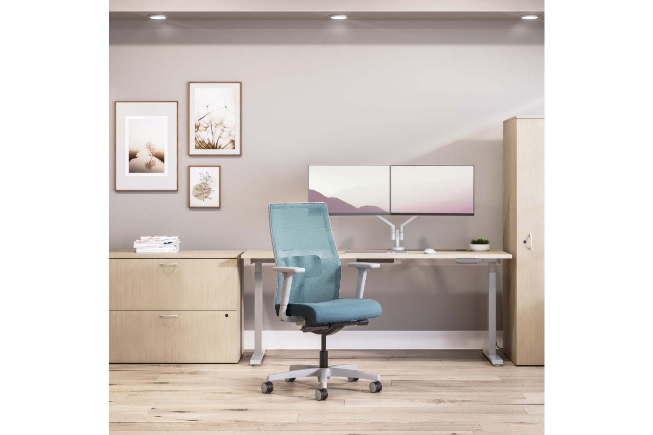Private office featuring Mod desk with height adjustable table and Ignition task seating in blue fabric.