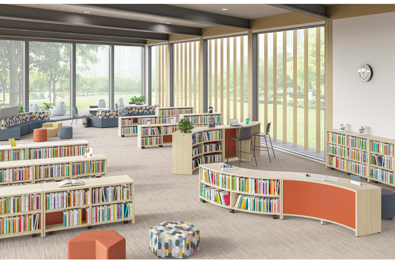 School media center featuring rows of Storyline bookcases and bistro tables to create spaces for reading or studying.