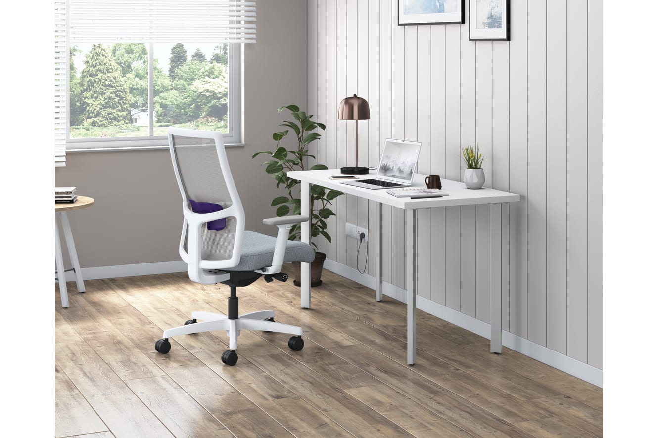 A modern and minimalist home office space with a white desk, a comfortable office chair, and a large window overlooking a lush outdoor landscape.