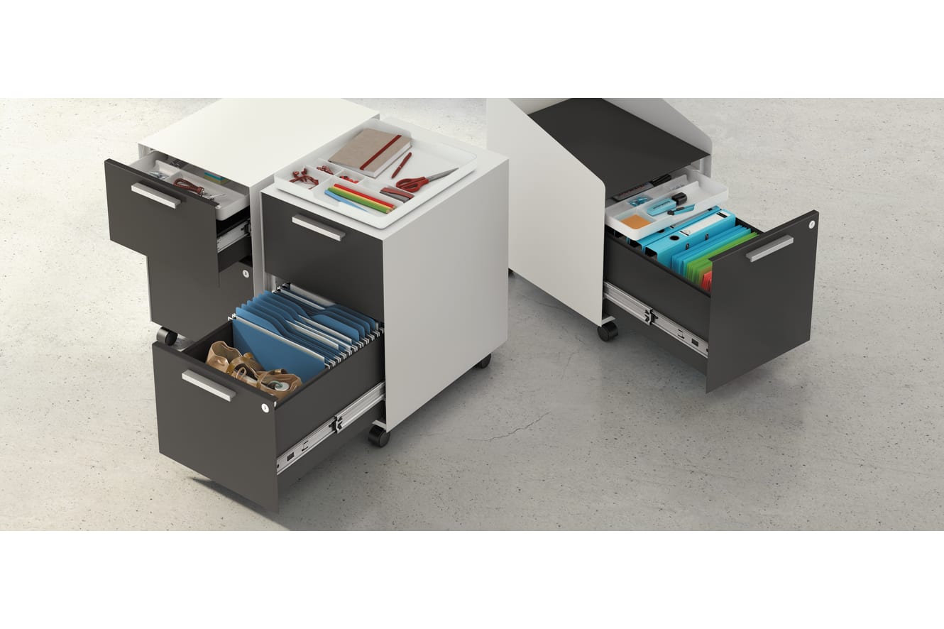 A black storage cabinet with multiple drawers and compartments, containing various office supplies and stationery items, sits on a light-colored floor.