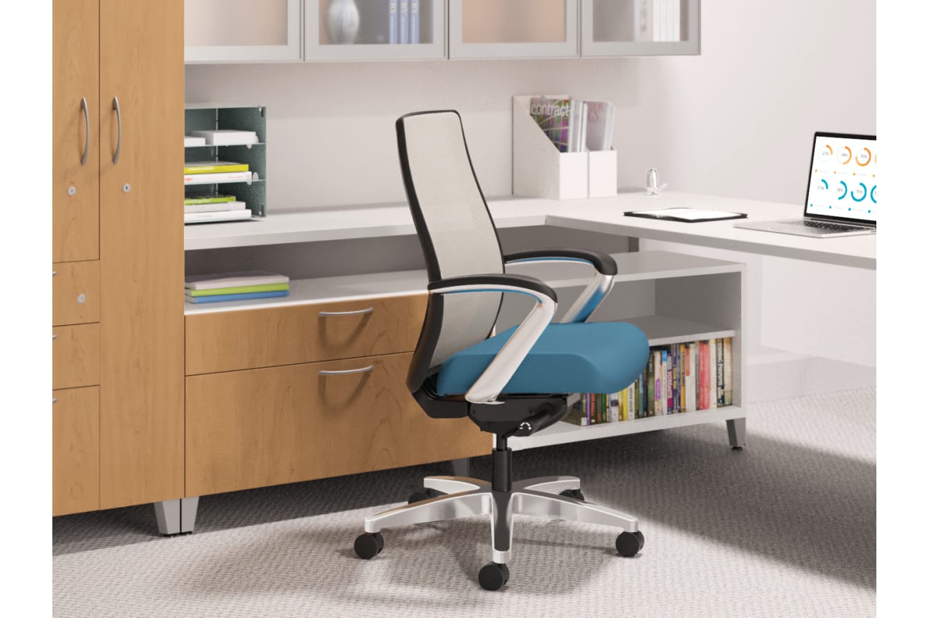 A modern, minimalist office workspace with a comfortable-looking office chair, shelves filled with books and documents, and a laptop on the desk.