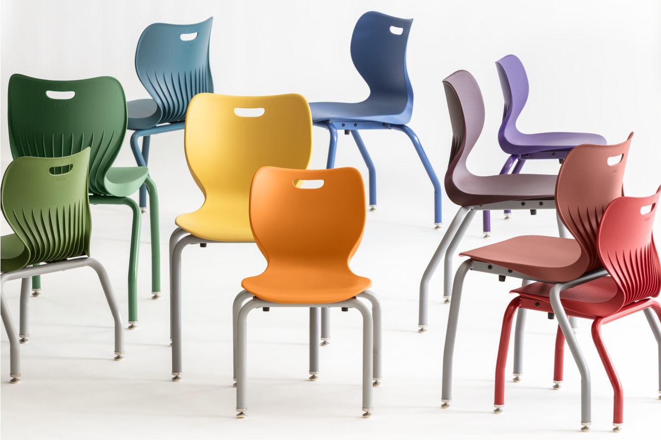 A collection of colorful, modern chairs in various shades of green, blue, yellow, and red, arranged against a plain white background.