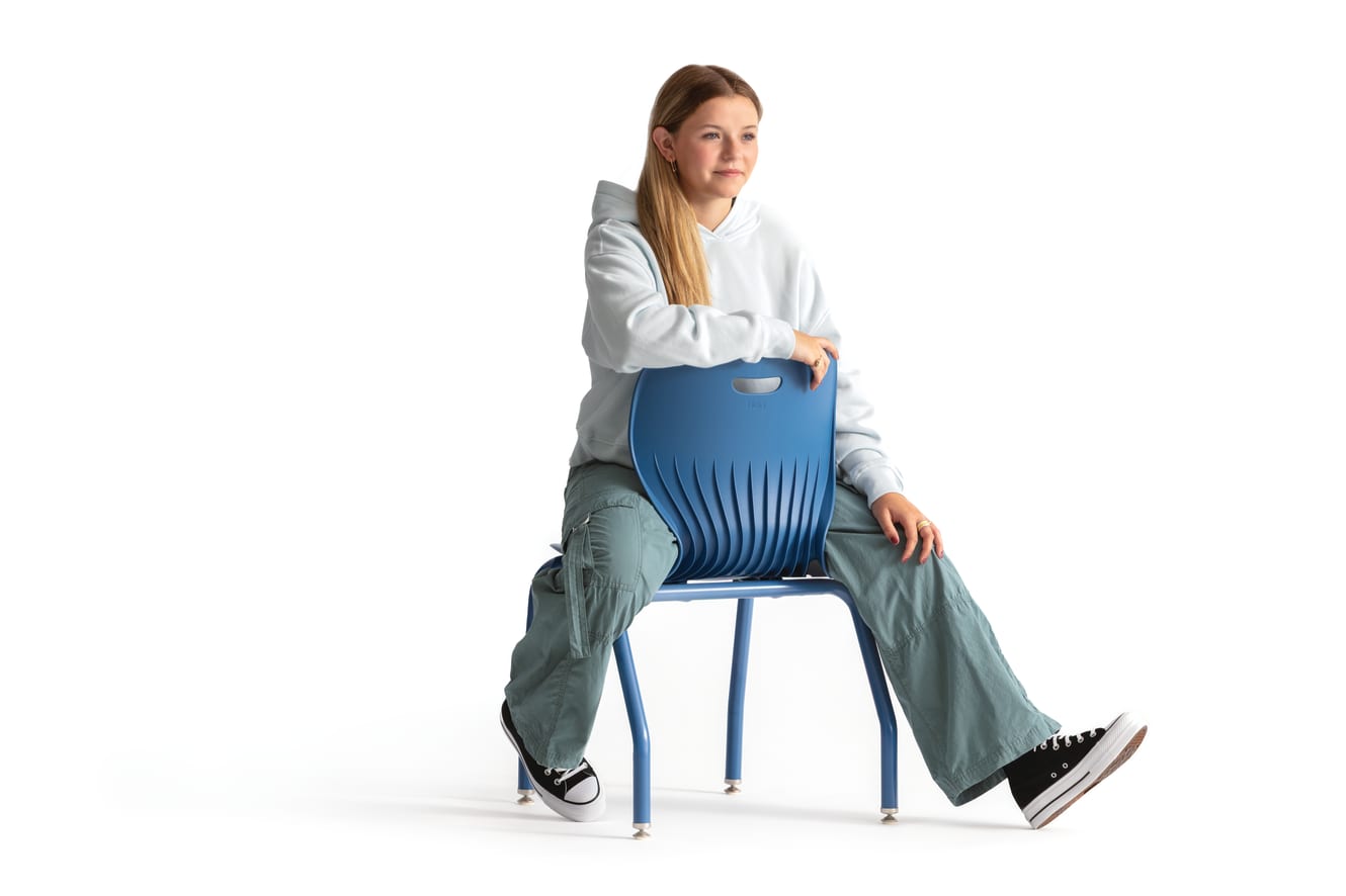 One seated student on a blue monotone Smartlink chair. One seated student on a blue monotone Smartlink chair. One seated student on a blue monotone Smartlink chair. One seated student on a blue monotone Smartlink chair. One seated student on a blue monoto