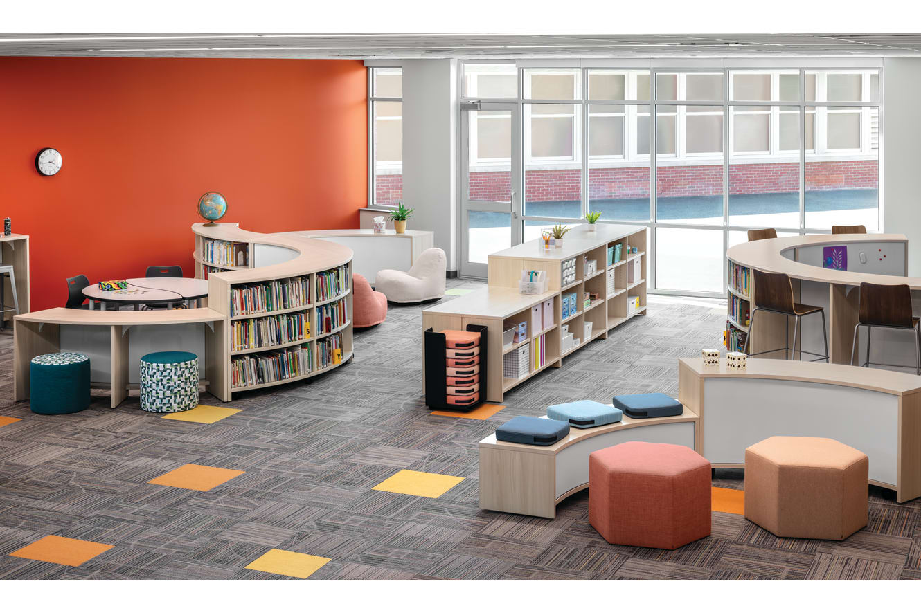 Storyline Bookcases and Bistro Tables with Confetti Floor Cushions and Lounges, Tangram Poufs, and Flock Minis.