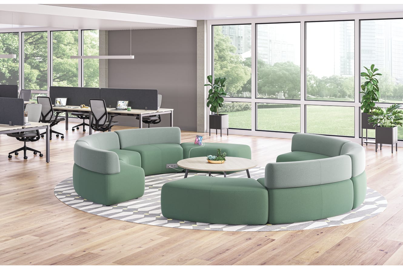 SoCo multi-fabric modular lounge in collaborative area with Scramble table and Sculpt planters near Empower workstations.