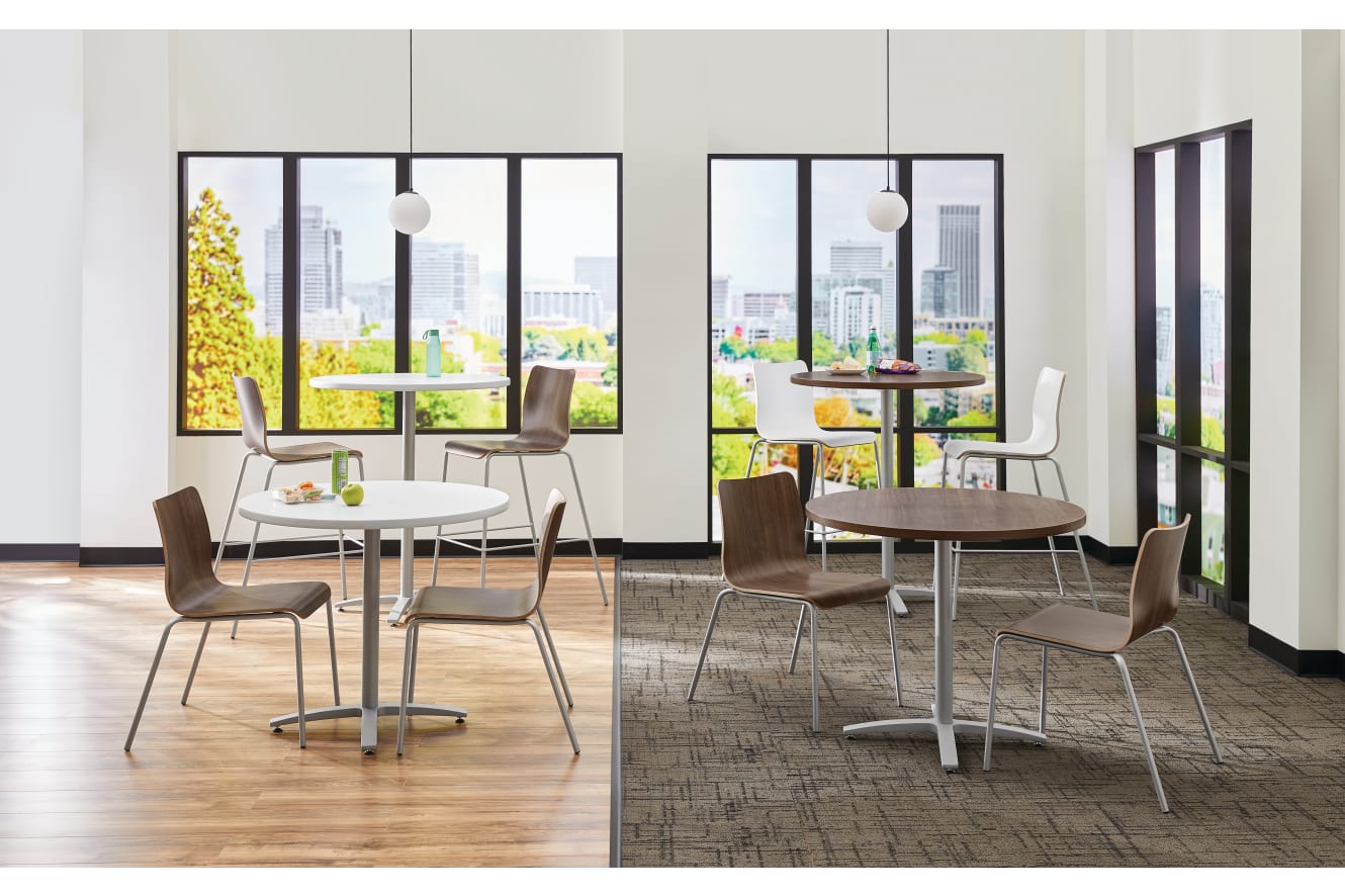 Between Standing and seated height tables with Ruck chairs in a café area
