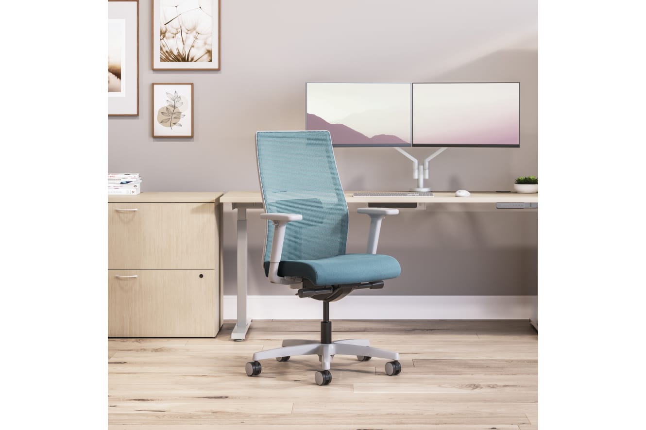 Private office featuring Mod desk with height adjustable table and Ignition task seating in blue fabric.