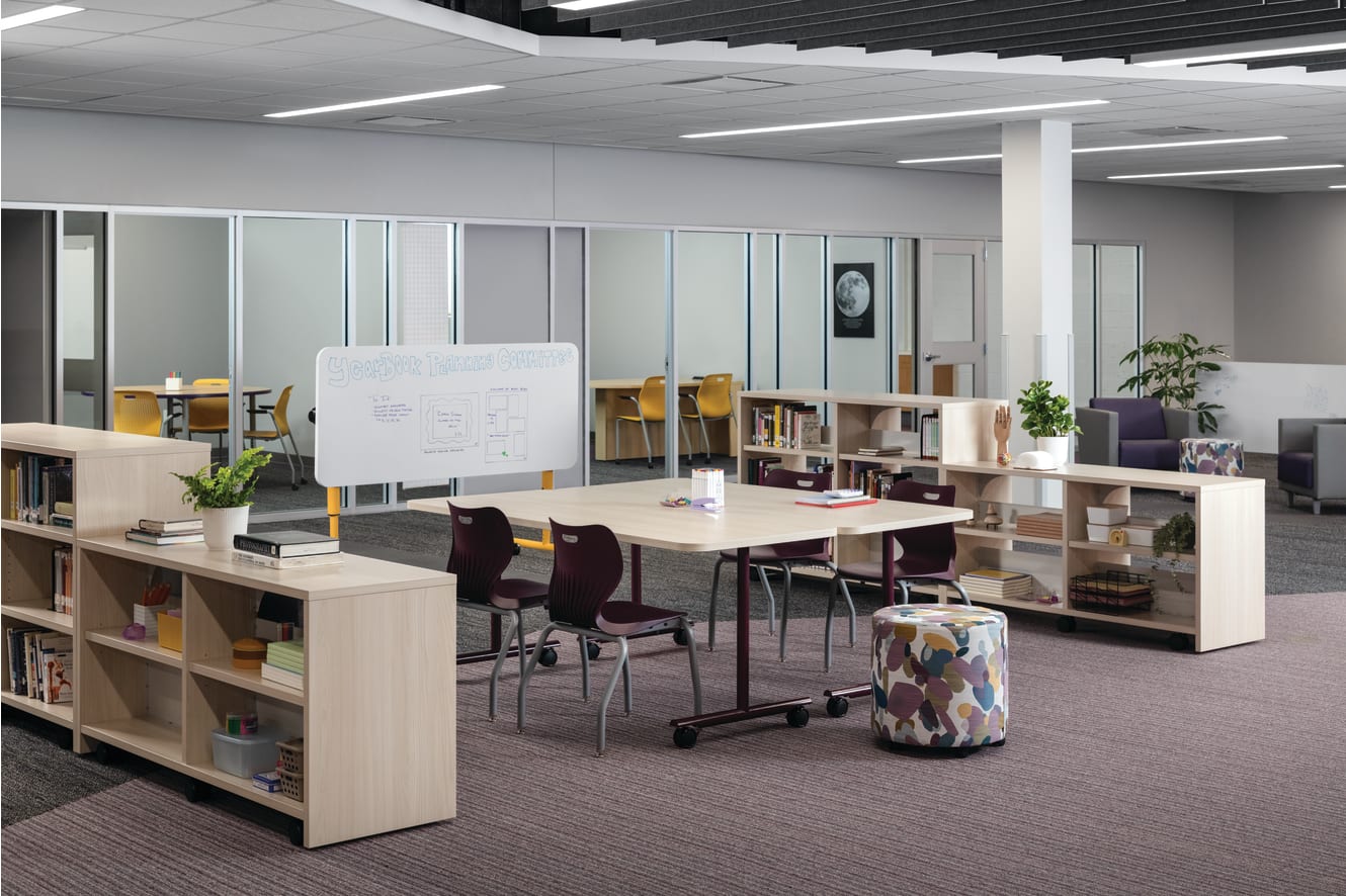 Field Trip tables with purple SmartLink chairs in a Multi-media Center with Storyline bookcases.