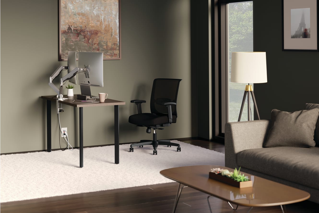 A modern and minimalist home office space with a sleek desk, a comfortable office chair, and a large window providing natural light, along with a cozy living area with a sofa and a coffee table.