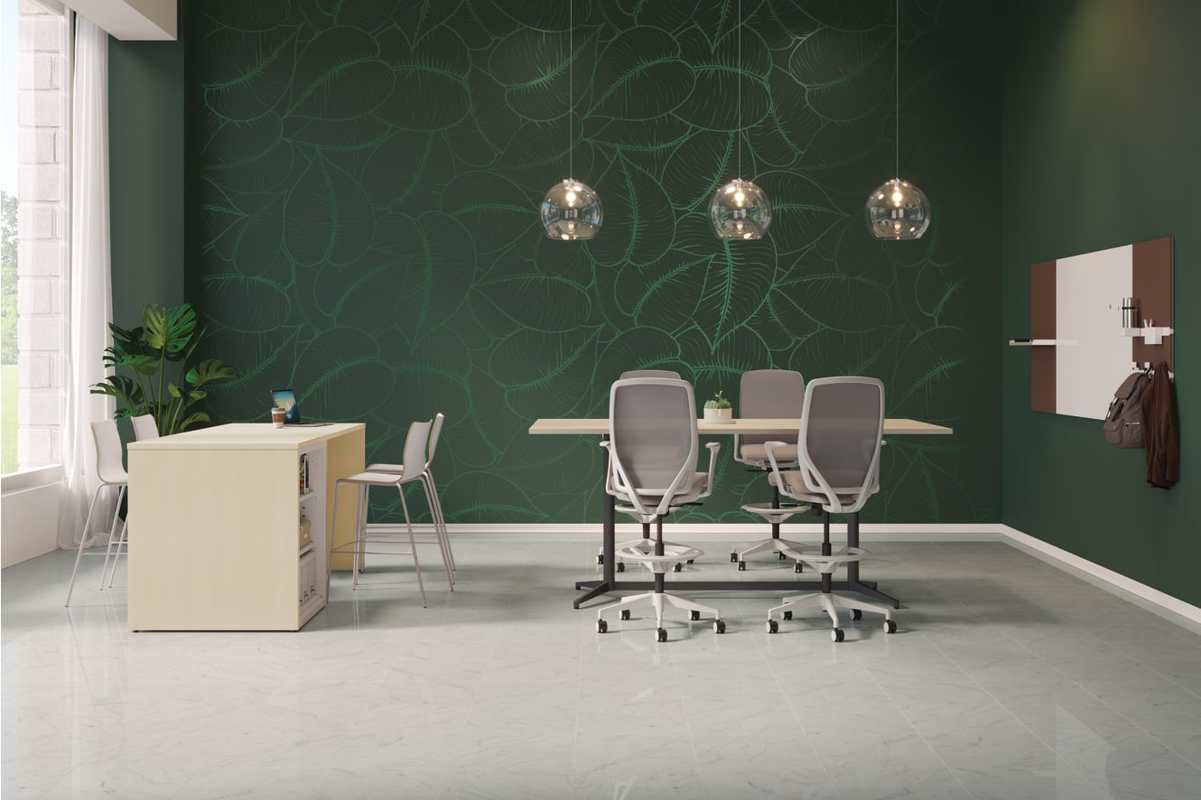 A modern and minimalist office space with a green accent wall, white furniture, and three hanging pendant lights.