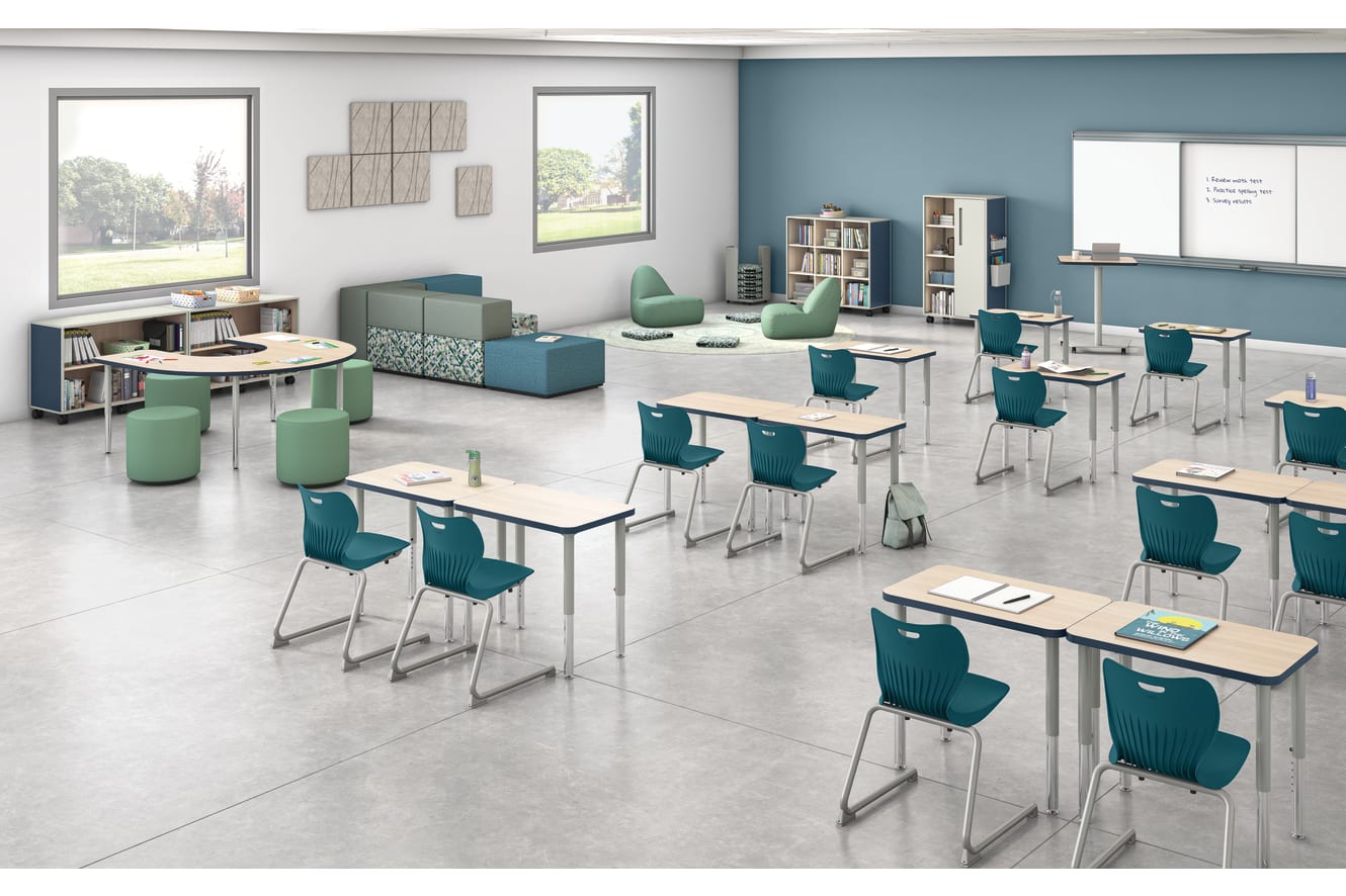 Classroom with flexible Build student desks, blue student chairs, and green soft seating.