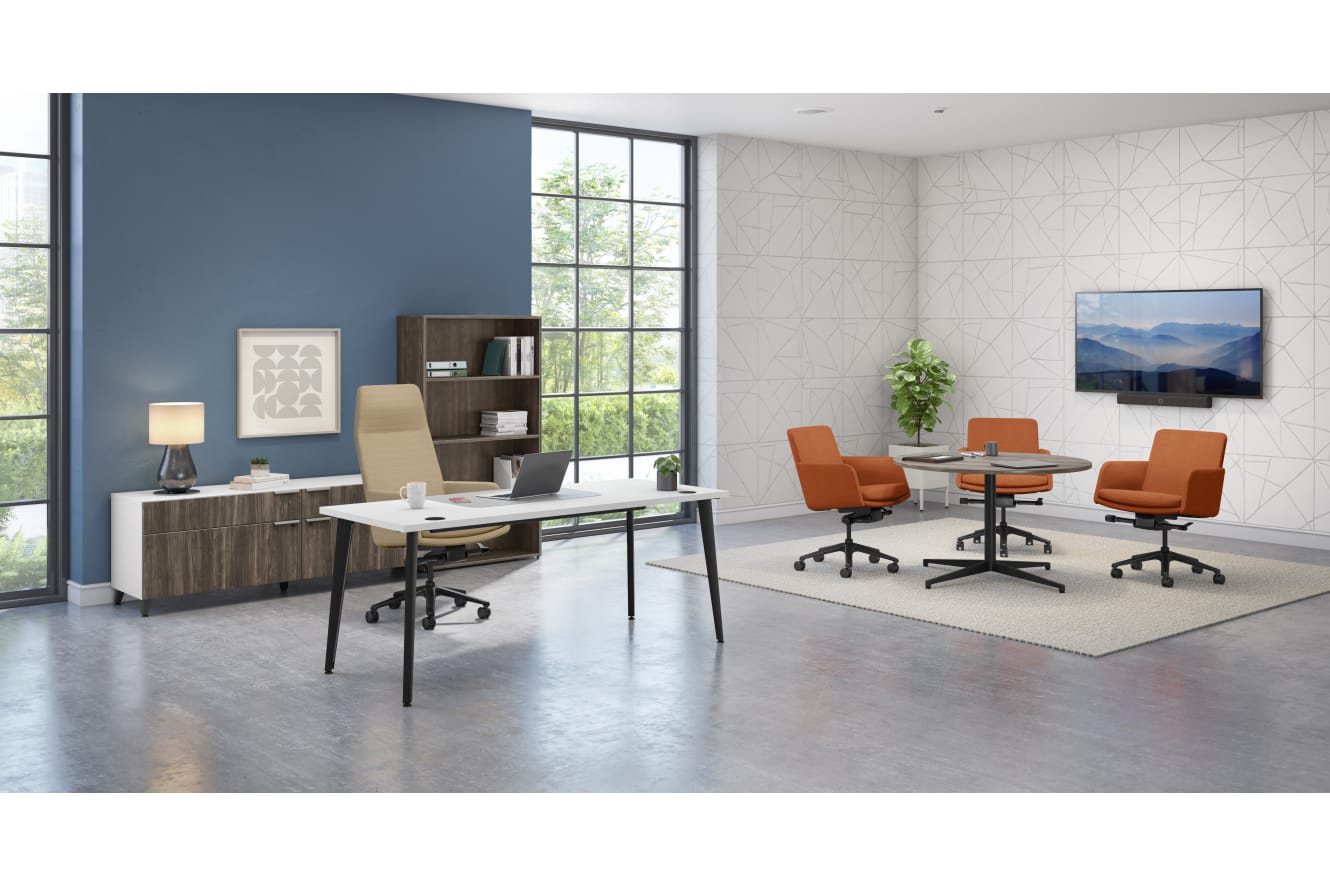 A modern and minimalist office space with a large window, a wooden desk, orange chairs, and various decor elements.
