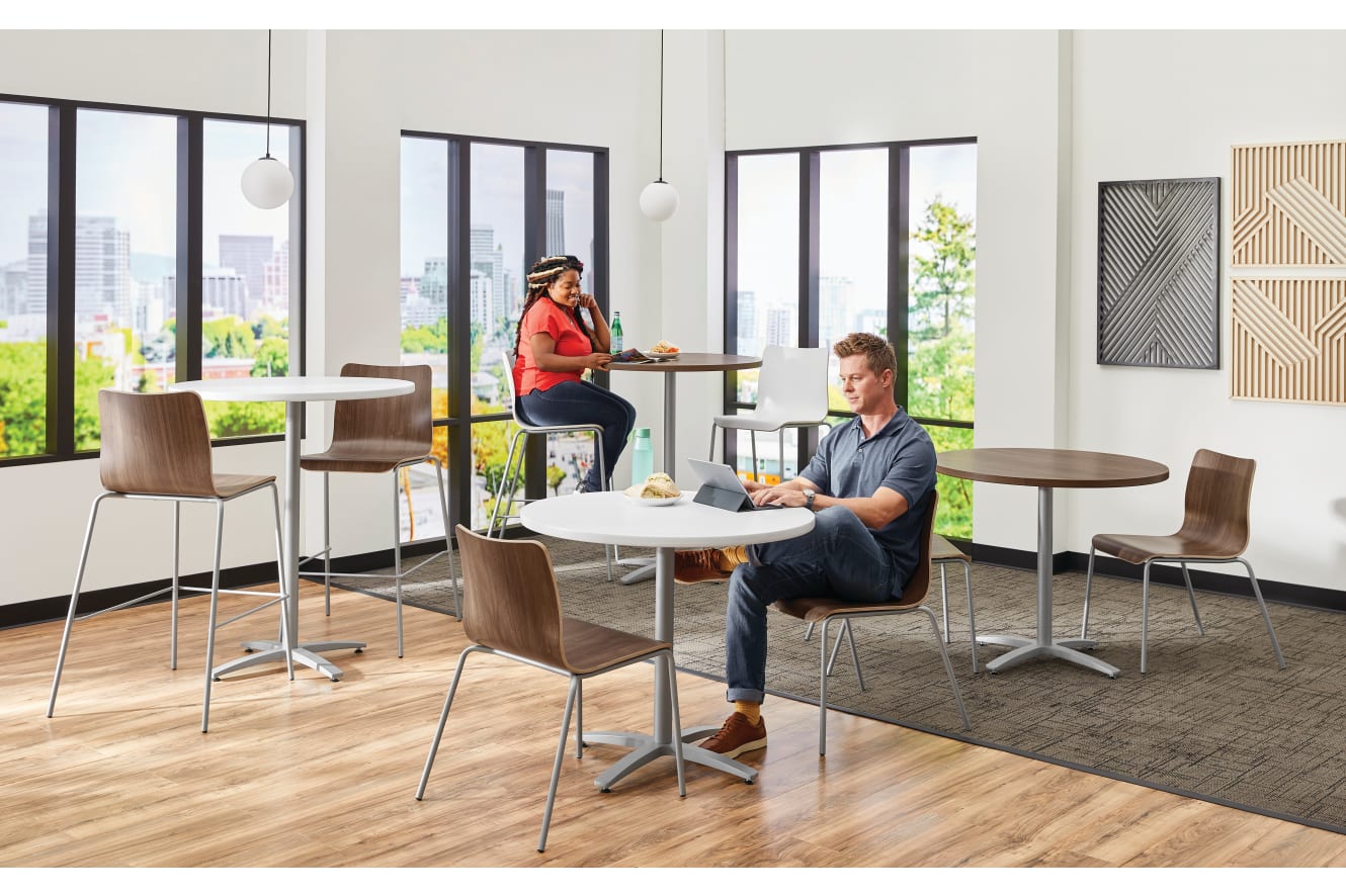 Between Standing and seated height tables with Ruck chairs in a café area