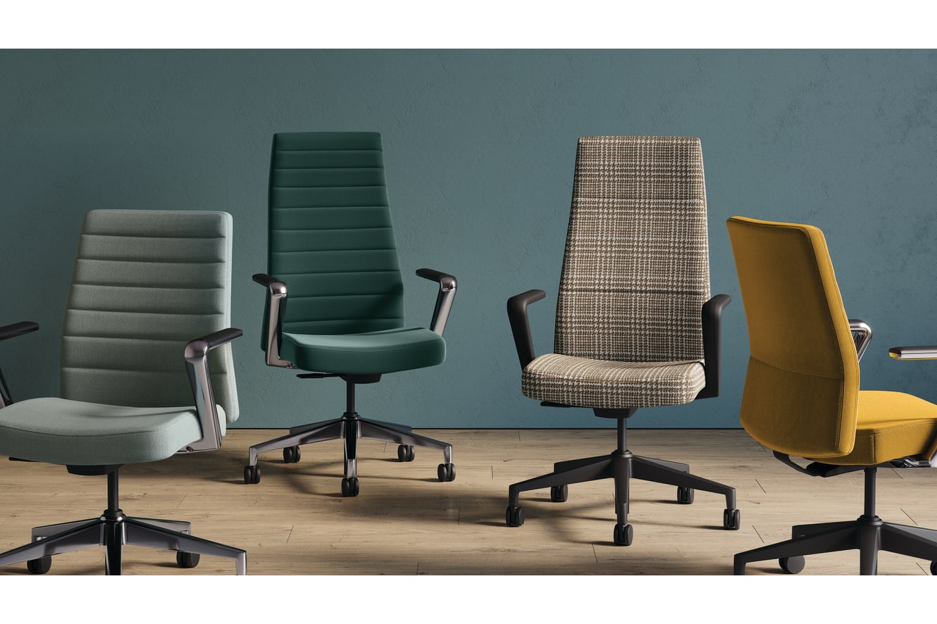 The image depicts several office chairs of various colors and designs, including gray, green, and patterned, arranged in a row on a wooden floor against a teal-colored wall.