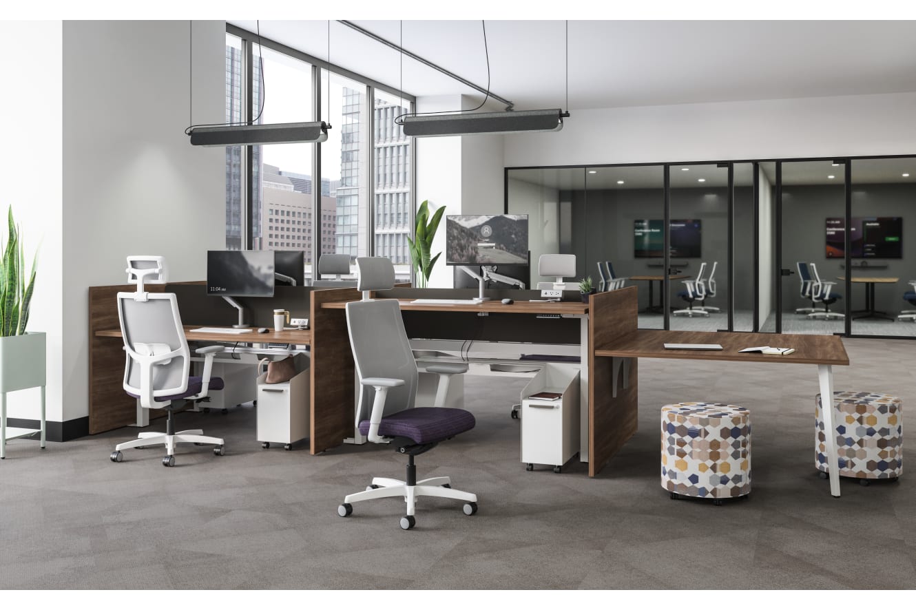 A modern and minimalist office space with desks, chairs, and various office equipment, surrounded by large windows providing natural light and a view of the exterior.