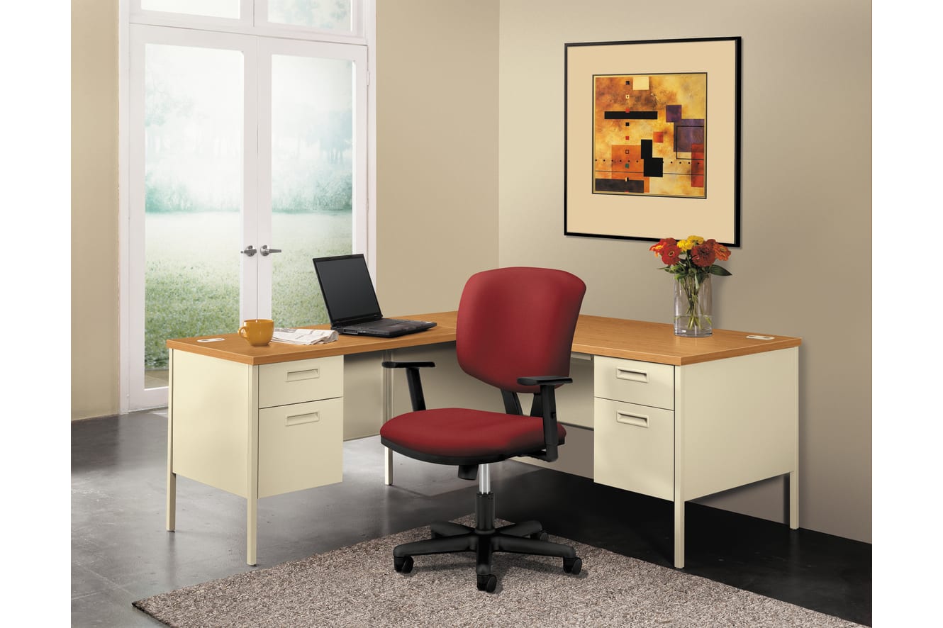 A modern home office with a wooden desk, a red office chair, and a framed abstract artwork on the wall, set against a backdrop of a large window overlooking a scenic outdoor view.