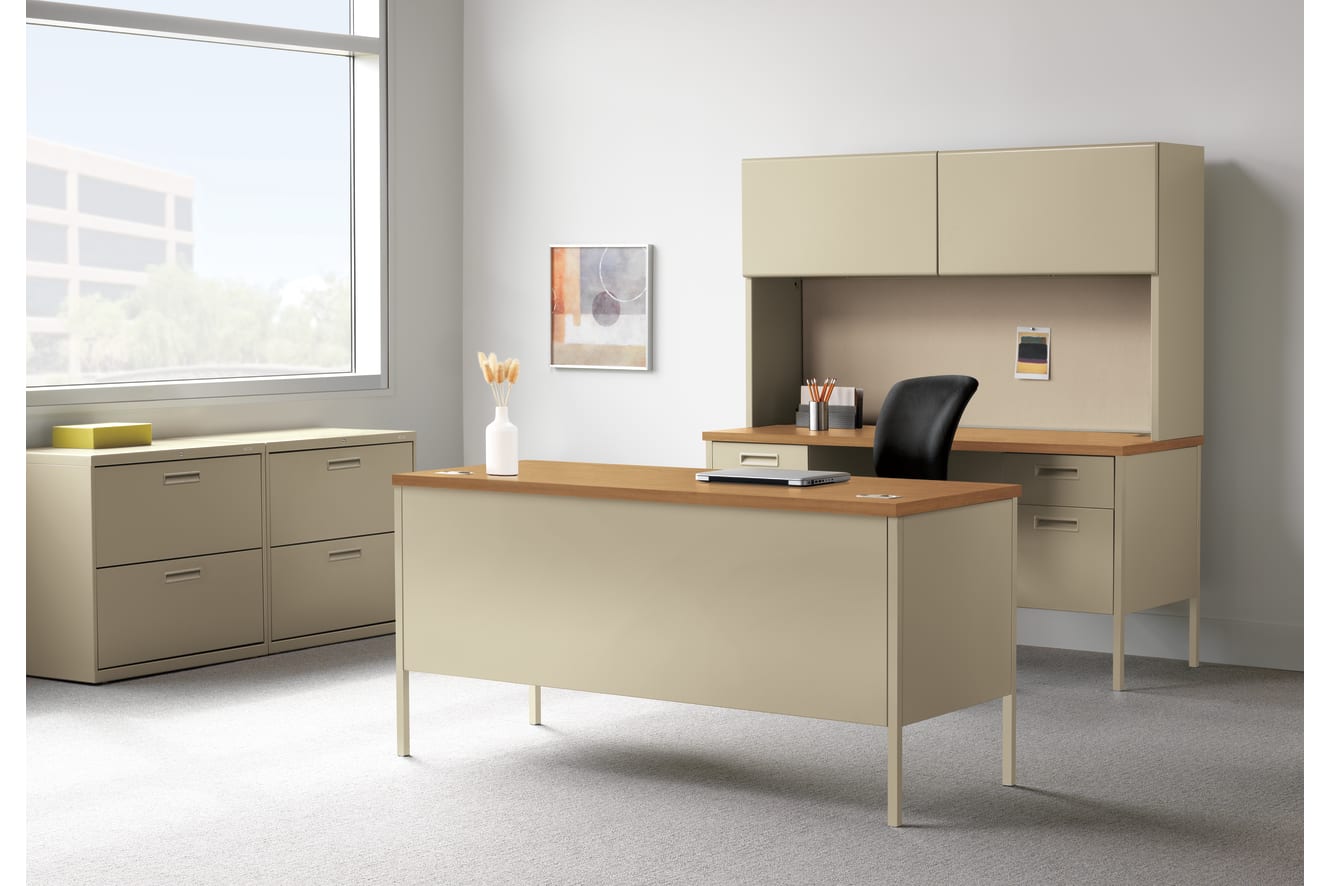 A modern and minimalist office space with a wooden desk, beige cabinets, and a large window providing natural light.