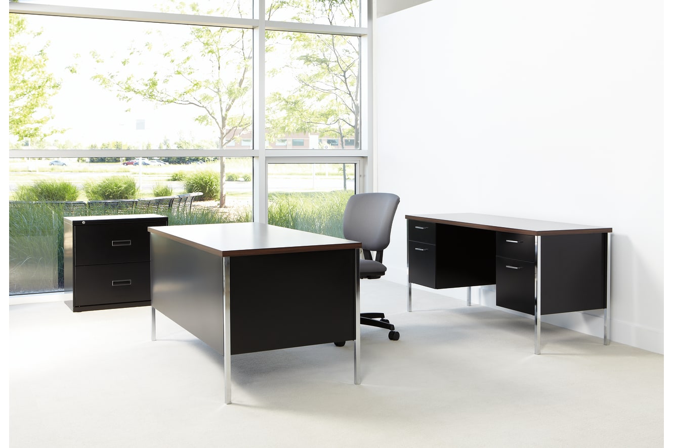 A modern and minimalist office space with a large window overlooking a lush, green outdoor environment. The room features sleek, black desks and filing cabinets, creating a clean and organized workspace.