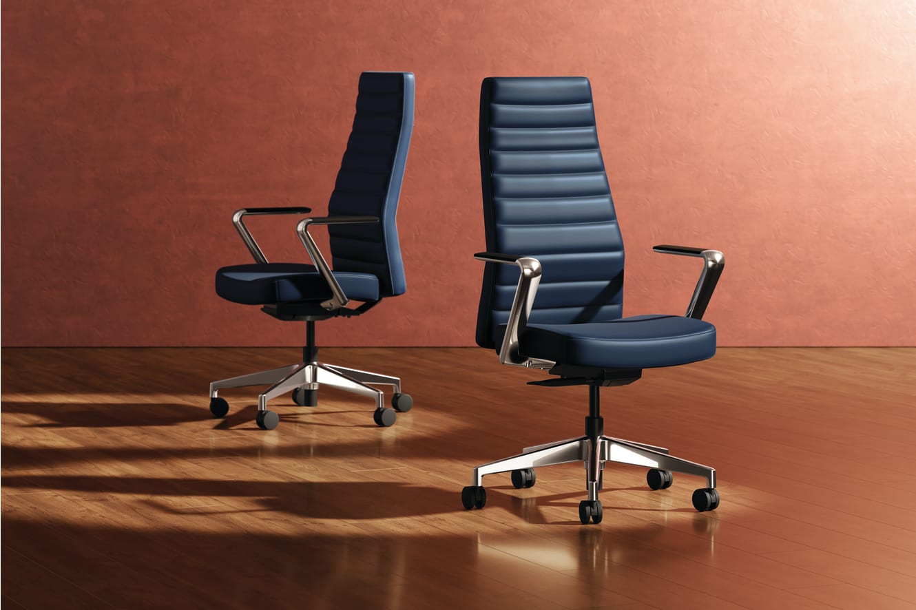 Two modern, high-back office chairs with black leather upholstery and chrome frames sit on a wooden floor against a warm, reddish-brown background.
